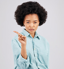 Image showing Finger, serious and portrait of black woman in studio with hand gesture for disagreement, upset and anger. Mockup space, white background and isolated girl point for angry, no and disappointment sign