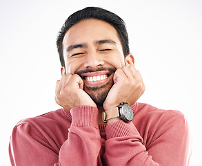 Image showing Happy man, smile and cute face in a studio looking attractive and handsome in emoji expression. Isolated, white background and Asian model with cheerful, silly or happiness pose dreaming about idea