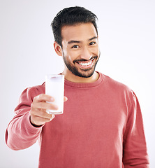 Image showing Milk, man and portrait with happiness in a studio with calcium, healthy and nutrition drink. Isolated, white background and male model with a smile feeling happy from weight loss and detox smoothie