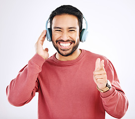 Image showing Headphones, smile and music, excited man in studio isolated on white background streaming radio and happiness. Podcast subscription, technology and song, Indian guy listening to audio online to relax