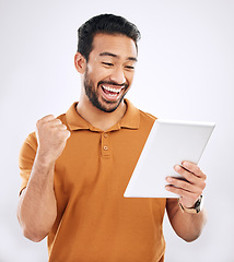 Image showing Tablet winner news, reading and happy man celebrate achievement, success goals or winning. Excited, studio and male celebration fist pump, victory announcement or notification on white background