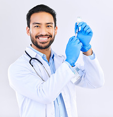 Image showing Portrait of doctor with smile, syringe and vaccine in studio for healthcare, medicine and innovation in medical science. Vaccination, booster shot and Indian man, virus protection on white background