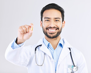 Image showing Doctor portrait, studio pills or happy man with pharmaceuticals, drugs or medicine supplement. Healthcare support, medical pharmacy or male pharmacist with prescription medication on white background