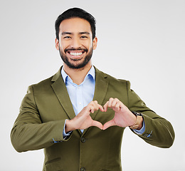 Image showing Portrait, heart and hand gesture with a business man in studio on a gray background for health or love. Hands, emoji and shape with a happy male employee showing a symbol or sign of affection