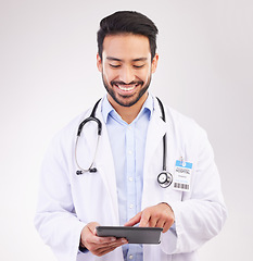 Image showing Happy asian man, doctor and tablet in healthcare research, Telehealth or communication against a white studio background. Male medical professional smiling on touchscreen for good health results