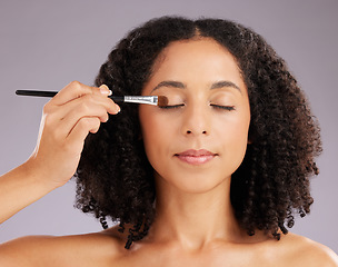 Image showing Woman, makeup and eyeshadow brush in studio for cosmetics, facial skincare and salon transformation. Female model, beauty and application on eyes for aesthetics, cosmetology or facelift on background