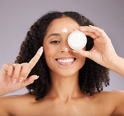 Image showing Woman, face and smile for skincare cream or beauty against a gray studio background. Portrait of happy female smiling and holding cosmetic product in healthy skin, self care or facial treatment