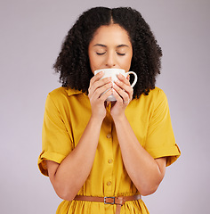 Image showing Woman, coffee and drinking mug in studio, backdrop and background for warm beverage, latte and smell of espresso. Female model enjoying cup of tea, cappuccino and good mood for break, calm and peace