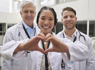 Image showing Heart hand, woman doctor and portrait with a healthcare and wellness team in a hospital. Happiness, love and emoji hands gesture with doctors in a medical clinic showing solidarity and community care