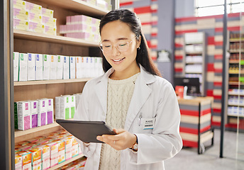 Image showing Pharmacist, tablet and Asian woman in pharmacy for healthcare or online consultation in drugstore. Telehealth, technology and happy person or medical professional with touchscreen for shop research.