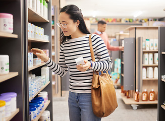 Image showing Asian woman, retail shopping and shelf in store for products, grocery stock and choice of brands. Female shopper, customer and supermarket aisle for groceries, sales decision and consumer buying