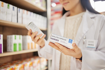 Image showing Pharmacist, hands and medicine box, pills or medication for healthcare or wellness. Medical professional, product and woman with antibiotics, pharmaceutical supplements and reading label in pharmacy.