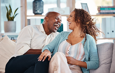 Image showing Love, happy and couple laugh on sofa for bonding, quality time and relaxing together at home. Marriage, interracial relationship and man and woman on couch embrace, hugging and laughing at funny joke