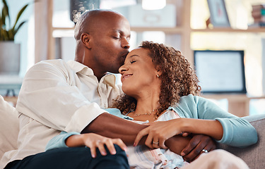 Image showing Love, kiss and couple relax on sofa for bonding, quality time and happiness together at home. Marriage, relationship and interracial man and woman on couch for calm, romance and embrace on weekend