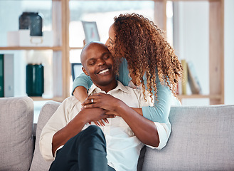 Image showing Love, happy and couple kiss on sofa for bonding, quality time and relaxing together at home. Marriage, interracial relationship and man and woman on couch embrace, hugging and laughing in living room