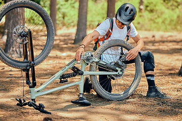 Image showing Maintenance, fitness and a man with a bicycle for cycling, fixing a wheel or tire in nature. Training, cardio and a cyclist repairing a bike, doing repairs and inspection for a race or competition