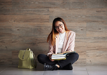 Image showing University, portrait of happy woman on floor with books on mockup space and education at college. Information, knowledge and backpack, student sitting on wall background with smile and book to study.