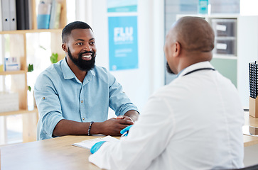 Image showing Doctor, black man and healthcare consultation with a wellness and hospital worker in a office. Consulting, patient and happy male with a smile from health communication and expert advice in a clinic