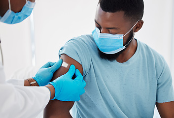 Image showing Bandage, covid vaccine with doctor and patient in hospital, safety from virus with plaster and healthcare. People in medical consultation, immunization and black man in face mask and injection wound