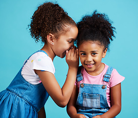 Image showing Whisper, secret and friends with children in studio for gossip, rumor and good news. Communication, mystery and innocence with young girls on blue background for conversation, secrecy or cute mockup