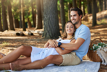 Image showing Couple in nature park, cuddle and happy relationship with love and trust, travel and adventure outdoor. Young people hug in forest, outside and happiness together with smile, commitment and care