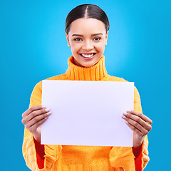 Image showing Smile, mockup and poster with portrait of woman in studio for idea, branding and announcement. Promotion, space and paper with female and sign on blue background for news, logo and advertising