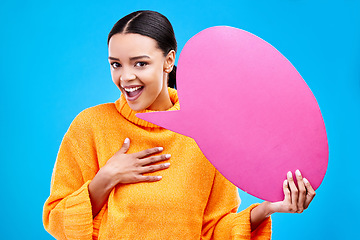 Image showing Speech bubble, wow and portrait of woman with banner in studio for advertising on blue background. Face, omg and female with poster, mockup and space for social media, announcement or billboard news