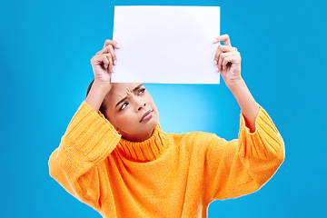 Image showing Paper, banner and confused woman in studio on blue background with space, mockup and poster. Billboard, poster and unsure girl showing blank copy space, branding or isolated logo announcement