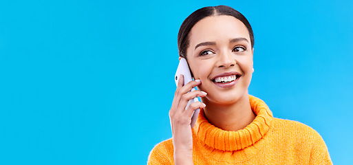 Image showing Happy woman, phone call and communication on mockup for social media, conversation or chat against a blue studio background. Female smiling on mobile smartphone in discussion or talking on copy space