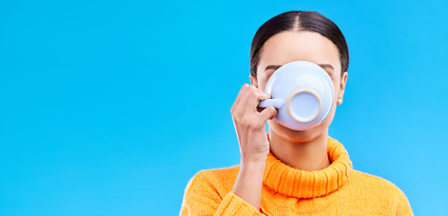 Image showing Cup, woman and drinking coffee on blue background, relax and enjoying a warm beverage on against a blue background. Tea, mug and girl relaxing on break with drink, caffeine or espresso in studio