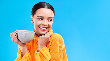 Image showing Coffee, woman and smile in studio with mockup and happiness and mug. Isolated, blue background and happy female model and young person with casual winter fashion and joy from tea drink smiling