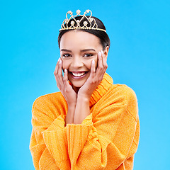 Image showing Happy, crown and portrait of woman in studio for celebration, princess and party. Smile, beauty and fashion with female and tiara on blue background excited for achievement, winner and prom event