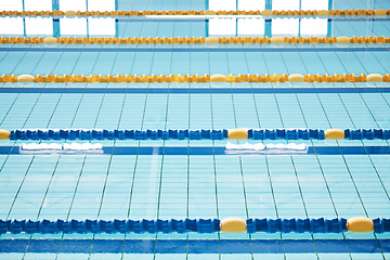 Image showing Empty, swimming pool or lines in water for competition or racing lanes for fitness or underwater sports. Background, blue or training arena ready for race performance, workout or exercise challenge