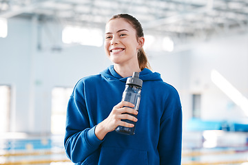 Image showing Swimmer, sports of happy woman drinking water to relax after exercise, workout or training on break. Hydrate, athlete fitness or girl smiling with happiness, motivation or liquid bottle for hydration