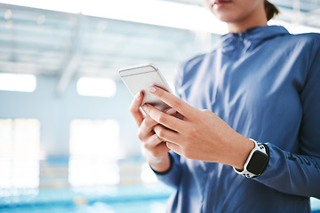 Image showing Hands, phone and athlete texting at swimming pool for social media, web scrolling or online browsing after exercise. Swim sports, cellphone and woman typing on internet chat after workout or training