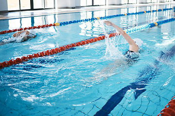 Image showing Sports, water splash or woman training in swimming pool for a race competition, exercise or cardio workout. Fast swimmer, freestyle stroke or healthy girl exercising with fitness speed or motivation