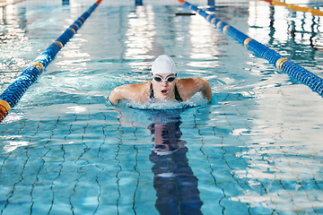 Image showing Sports, swimming pool or woman training in water for a race competition, exercise or cardio workout. Athlete swimmer, wellness or healthy girl exercising with fitness speed, motivation or resilience