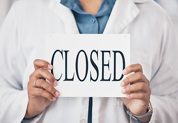 Image showing Hands closeup, closed sign and small business for store, pharmacy or shop in recession, bankrupt and retail. Woman pharmacist, poster or board for announcement for medical shopping for healthcare