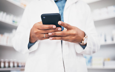 Image showing Hands, phone and healthcare with a pharmacist woman at work in a drugstore or dispensary for communication. Pharmacy, mobile and contact with a female medicine professional working in an apothecary