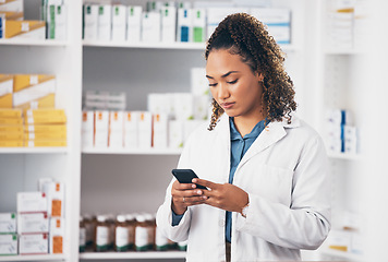 Image showing Pharmacist woman, smartphone and texting in store for contact, email communication or reading chat. Pharmacy, female and phone for social media app, typing and medical news on internet in workplace