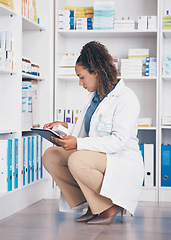 Image showing Tablet, stock and health with a pharmacist woman at work to fill an online order or prescription. Healthcare, product and insurance with a female working as a medicine professional in a pharmacy