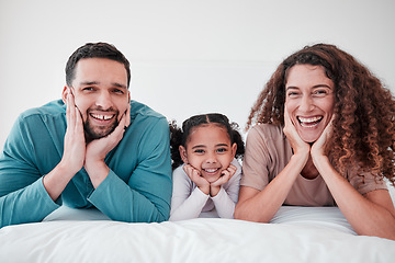 Image showing Family, portrait and parents with child, smile and relax with happiness, love and care in bedroom. Spending quality time together, bonding and relationship, man and woman with young girl at home