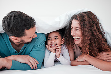 Image showing Family in bed, parents laughing with child and relax with smile under blanket in bedroom with love and care. Spending time together, bonding and relationship, man and woman with young girl at home