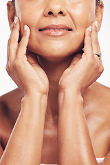 Image showing Hands, mouth and skincare with a mature woman in studio for beauty, anti aging treatment or cosmetics. Skin, facial and wellness with a senior female touching her smooth face for hydration closeup