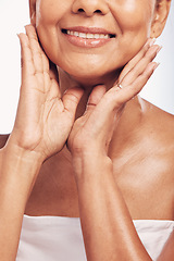 Image showing Hands, mouth and skin with a mature woman in studio for beauty, anti aging treatment or cosmetics. Skincare, facial and wellness with a senior female moisturizing her face for hydration closeup