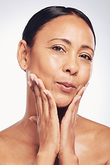 Image showing Skincare, glow and the portrait of a mature woman isolated on a white background in a studio. Happy, anti aging and a beauty model touching glowing skin, feeling softness and clear complexion