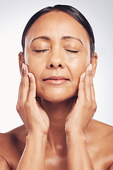 Image showing Senior woman, face and anti aging skincare, beauty and dermatology with natural cosmetics isolated on studio background. Female eyes closed, hands and wellness with cosmetic care and skin glow