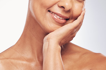 Image showing Hand, mouth and skincare with a mature woman in studio for beauty, anti aging treatment or cosmetics. Skin, facial and wellness with a senior female touch her face for happy self care closeup