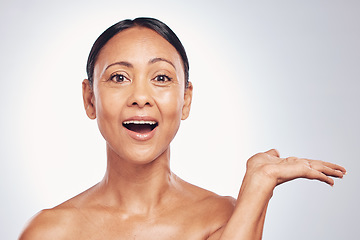 Image showing Wow, skincare and portrait of a woman with space for product placement isolated on a studio background. Advertising, shock and a mature model showing mockup for branding, beauty and cosmetics