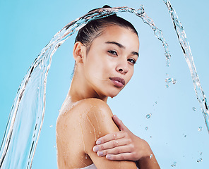 Image showing Water drops, skincare and portrait of woman with health, wellness and hygiene isolated on blue studio background. Shower, dermatology and cosmetic beauty glow, model in skin care treatment or routine